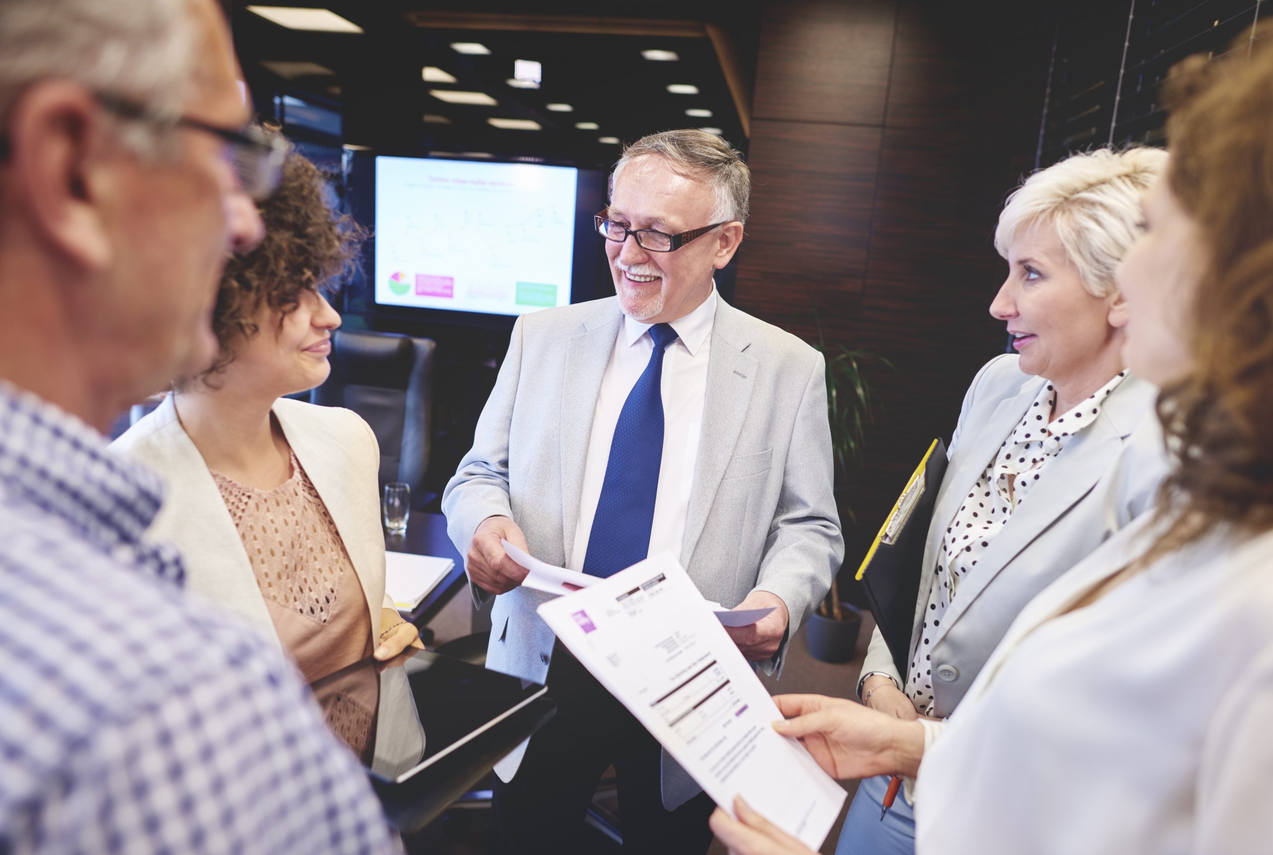 Public speaker deliberating with coworkers